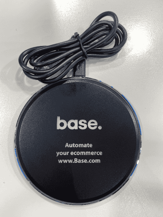 sleek wireless charger, branded with the Base logo 